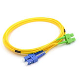 Close-up of blue SC/UPC and green SC/APC hybrid connectors on single mode duplex fiber patch cable
